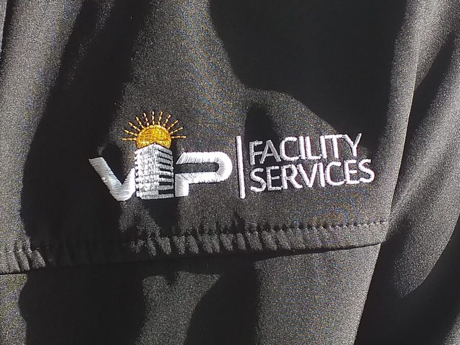 vipfs facility services logo on a black suite