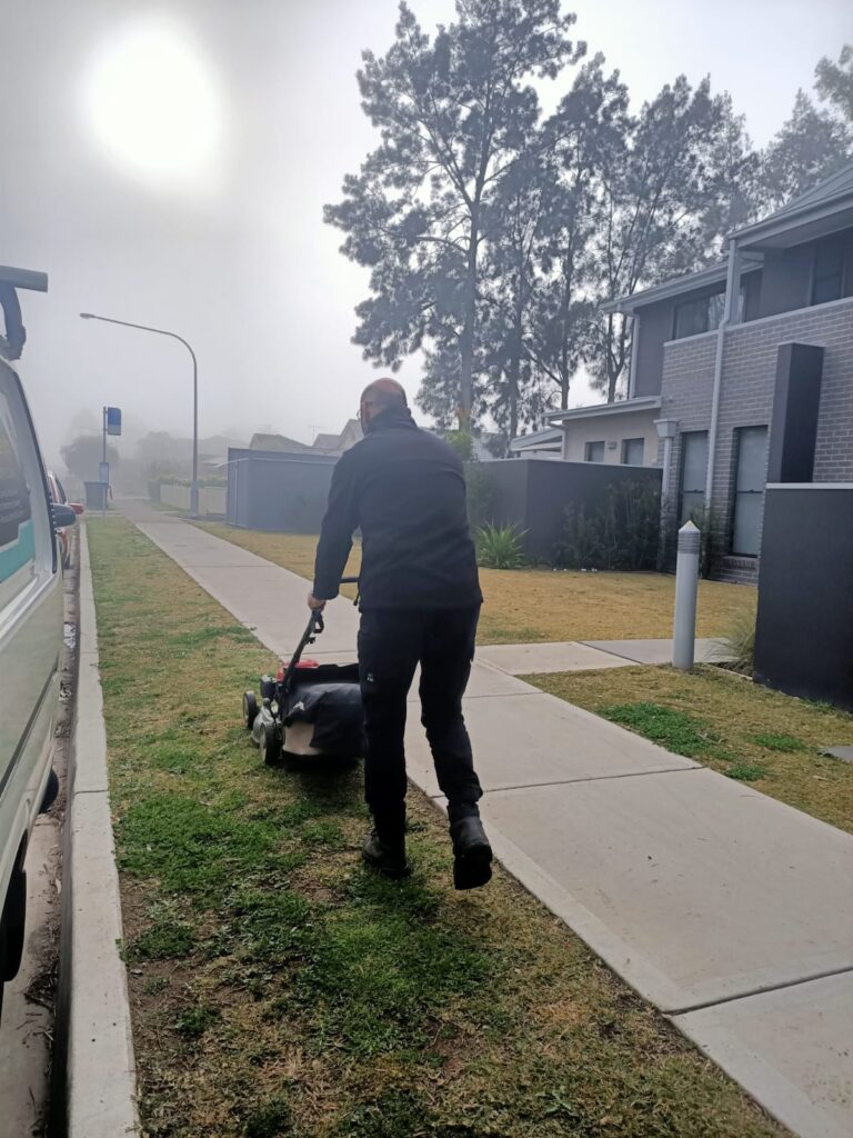 vipfs employee is mowing the garden of outside a building