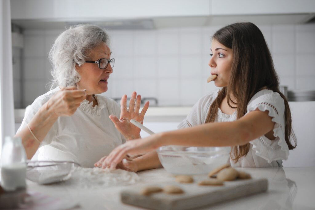 a pensive granmother with granddaughter having interesting chatting presenting the page of healthcare offered by vipfs