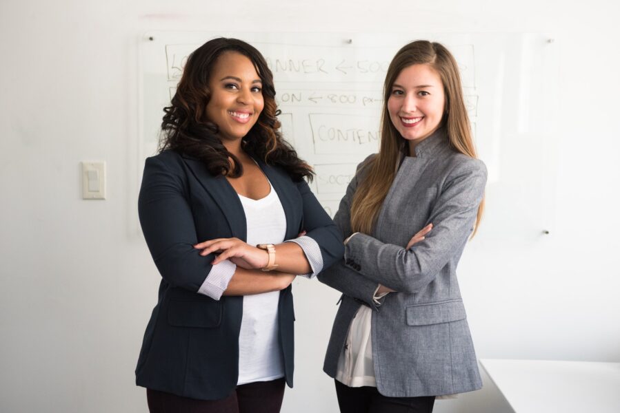 two smiling women in gray an black coat standing in a school cleaned by vipfs