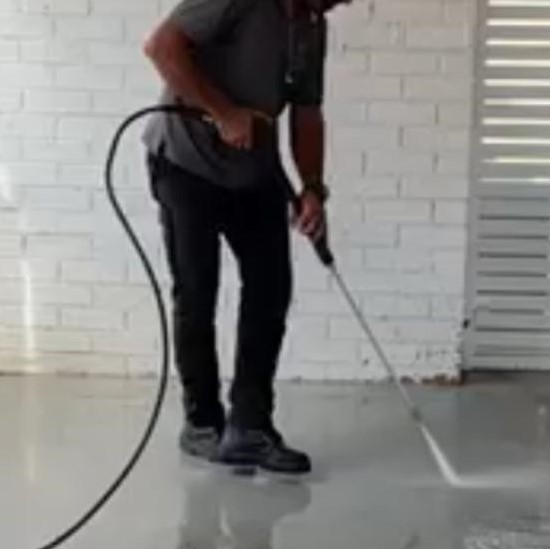 vipfs employee using high Pressure Washing the driveway