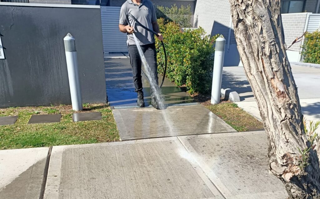 vipfs employee using high pressure washer cleaning